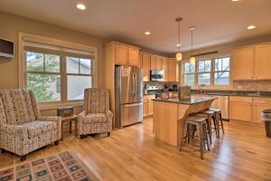 a kitchen with wooden cabinets and a island with bar stools at Less Than Half-Mi to Skiing Lake Harmony Home with Hot Tub in Lake Harmony
