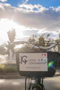 a basket on a bike with a hotel continental sign at Hotel Continental in Tortoreto Lido