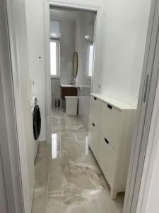 a white bathroom with a sink and a washing machine at Appartamento confortevole M.I. Casa in Cusano Milanino
