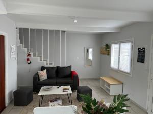 a living room with a couch and a staircase at Alma del Susana in Ushuaia