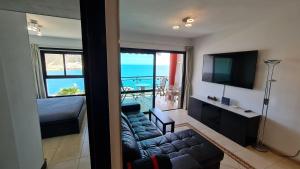 A seating area at DELUXE 3 Rooms74m2,TRANSFE-R inc! SEAVIEW on AMADORES,2 heatPOOLs, PARKING, 600 MB,Dishwasher,2Lift,,3 BEACHes