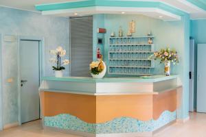 a dressing room with a counter with flowers on it at Hotel Continental in Tortoreto Lido