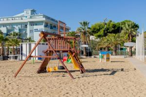 a playground in the sand on the beach at Hotel Continental in Tortoreto Lido