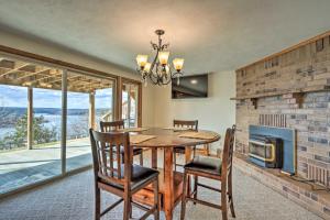 a dining room with a table and a fireplace at Lakeside Home with Deck Near Hunting and Fishing in Galmey