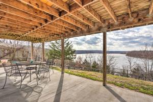 a patio with a table and chairs and a view of a lake at Lakeside Home with Deck Near Hunting and Fishing in Galmey