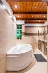 a bathroom with a large tub in a room at Erika's House. in Érd