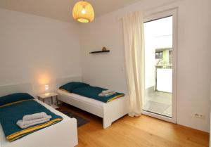 A bed or beds in a room at Modern Balcony Apartment with free Parking