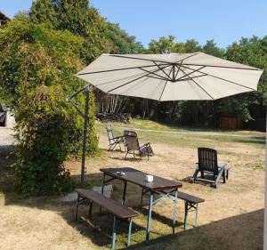 a table and two chairs and an umbrella at Mulino Valsorda in Magnano