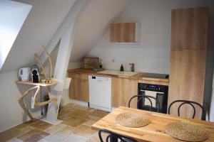 a kitchen and dining room with a table and chairs at Appartement classé "La Tour" in Dole