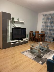 a living room with a television and a table at Peaceful living, 4 minutes from the city center in Košice