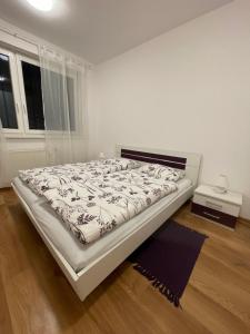 a white bedroom with a bed in a room at Peaceful living, 4 minutes from the city center in Košice