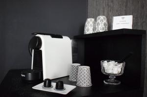 a black counter with a toaster and other items on it at Studio au Moulin " Design Noir " Vue Unique in Dole
