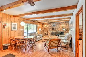 a living room with a table and chairs at Riverfront Home near Yosemite National Park! in Groveland