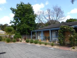 a house with a driveway in front of it at The Balnarring Motel in Balnarring