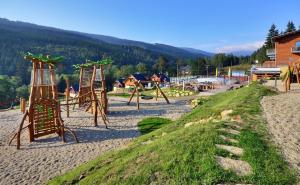 a playground with a swing set on a beach at Hotel Jirinka in Dolní Morava +109 photos