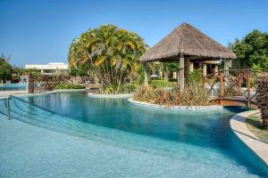 a swimming pool at a resort with a playground at Residence in Barra de São Miguel