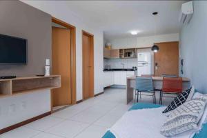 a living room with a kitchen and a dining room at Residence in Barra de São Miguel