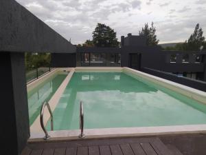 a large swimming pool in a building at Lake 360 Apart Villa Carlos Paz in La Cuesta