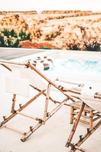 a chair in front of a swimming pool at Casa-Simplicity 