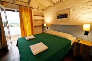 Cama o camas de una habitación en Pousada do Morro