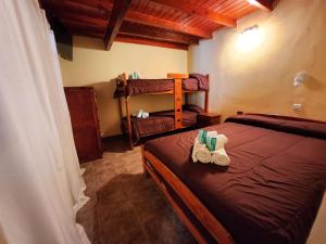 a bedroom with a bed with two towels on it at Hotel Los Ángeles in San Clemente del Tuyú