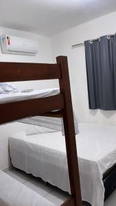 a pair of bunk beds in a room at Apartamento em Pipa in Pipa