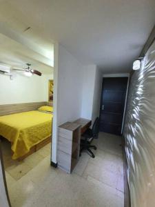a bedroom with a bed and a desk in it at R.1111 Estudio ejecutivo, práctico, en el centro. in Panama City