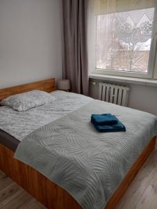 un letto con un asciugamano blu in una camera da letto di Apartament Czeladź 60m2 Centrum Katowic 10km a Czeladź