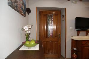 a room with a bowl of fruit on a table with a door at Apartamentos Casa Margot in Sevares