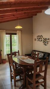 a dining room with a table and chairs and a couch at Departamento Parras del Abuelo 2 in Malargüe