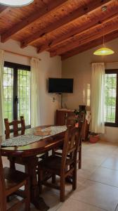 a dining room with a wooden table and chairs at Departamento Parras del Abuelo 2 in Malargüe