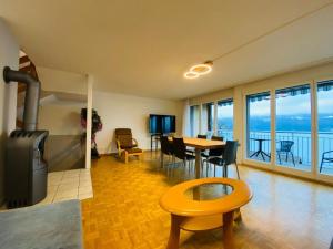 ein Wohnzimmer mit einem Tisch und ein Zimmer mit Aussicht in der Unterkunft Lake View Apartment - 12 in Niederried