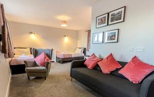 a living room with a couch and a bedroom at Broadford House Skye in Broadford