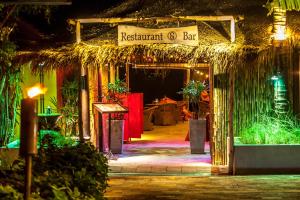 a resort entrance with a restaurant bar at night at Secret Garden Beach Resort in Bangrak Beach