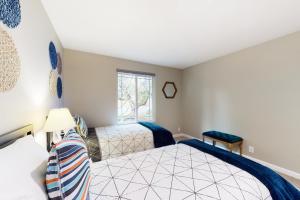 a bedroom with two beds and a window at Blue Door House in Bothell
