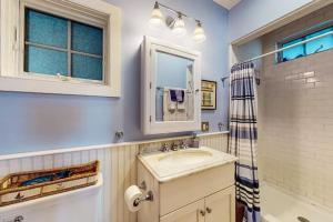 a bathroom with a sink and a shower at Commercial Street Retreat in Provincetown +5 photos