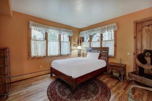 a bedroom with a bed and two windows and a rug at The Perfect Large Family Retreat condo in Beaver Creek