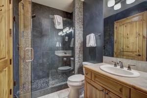 a bathroom with a toilet and a sink and a shower at The Perfect Large Family Retreat condo in Beaver Creek