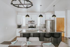 a kitchen with a large island with chairs in it at The Circle Unit B in Bozeman