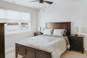 a bedroom with a large bed and a ceiling fan at The Circle Unit B in Bozeman