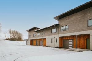 a large building with a garage in the snow at The Circle Unit B in Bozeman