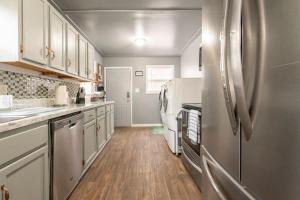 a kitchen with white cabinets and a stainless steel refrigerator at Mystic Island #1 in Birmingham