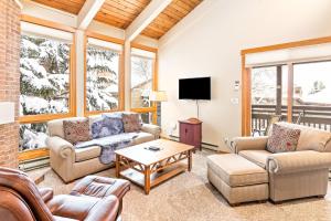 a living room with two couches and a tv at Lodge at Steamboat A309 in Steamboat Springs