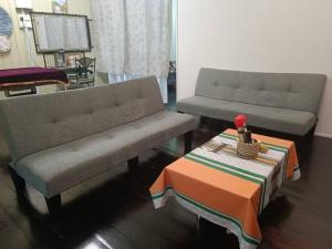 - un salon avec deux canapés et une table dans l'établissement 大街小巷民宿 Pulau Ketam Street Homestay, à Bagan Teochew