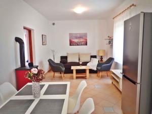 a living room with a couch and a table at Apartment in Starigrad-Paklenica 43216 in Starigrad-Paklenica