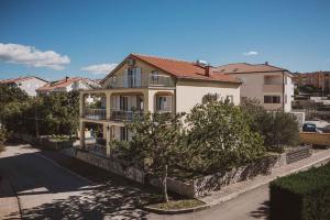 dom na ulicy z drzewami i budynkami w obiekcie Apartments in Klimno - Insel Krk 43356 w mieście Klimno