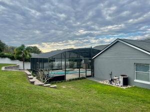 a house with a swimming pool inside of it at Dreamy Family Pool House in Clermont