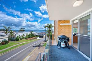 a stroller is parked on the side of a house at The Crest in Shoal Bay