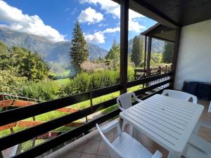 a white table and chairs on a balcony with mountains at Apartment in Ledro - Ledrosee 43436 in Ledro