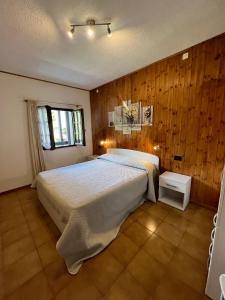 a bedroom with a large bed and wooden walls at Apartment in Ledro - Ledrosee 43436 in Ledro
